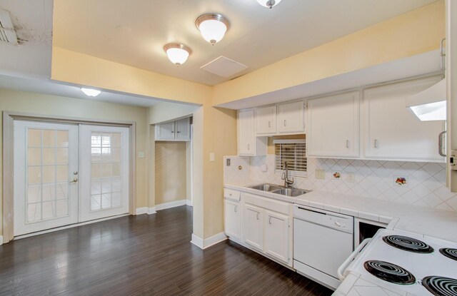 kitchen with ventilation hood, sink, white cabinets, white appliances, and dark hardwood / wood-style flooring