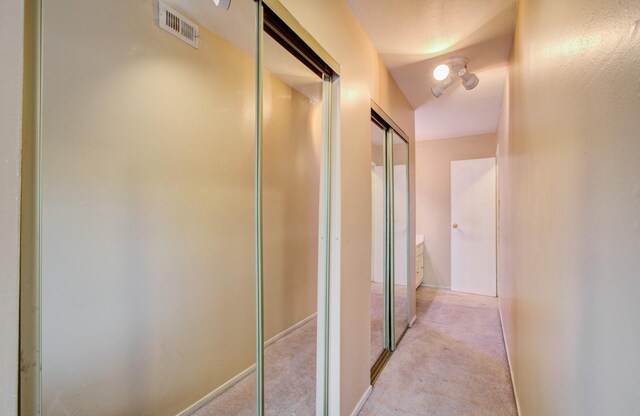 corridor with light colored carpet