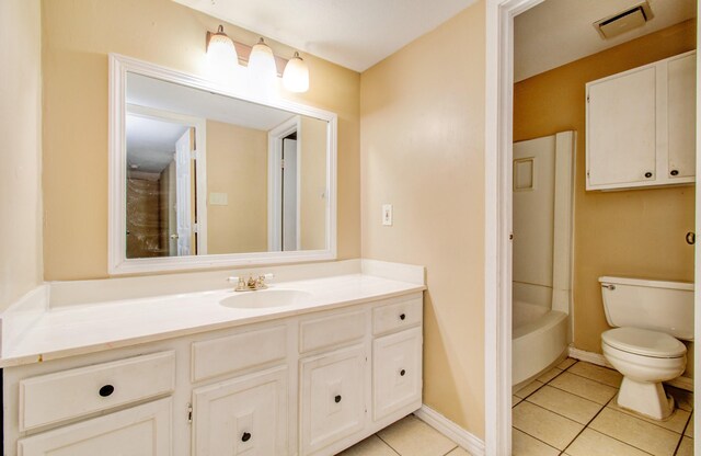 bathroom featuring vanity, toilet, and tile patterned floors