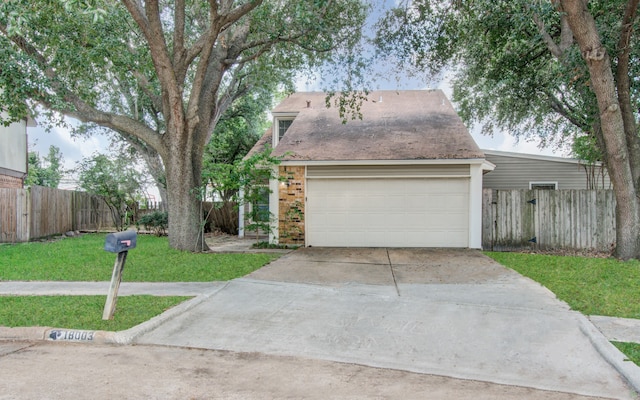 view of front of house with a front lawn and a garage