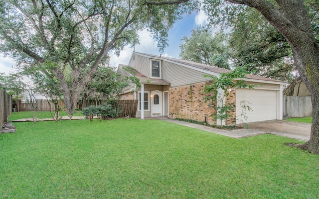 view of front of house with a front yard and a garage