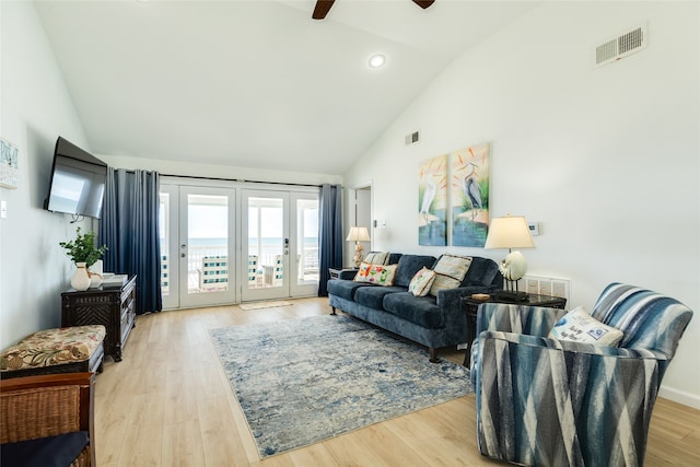 living room with high vaulted ceiling, light hardwood / wood-style floors, and ceiling fan