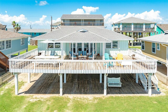 rear view of property featuring a yard and a wooden deck