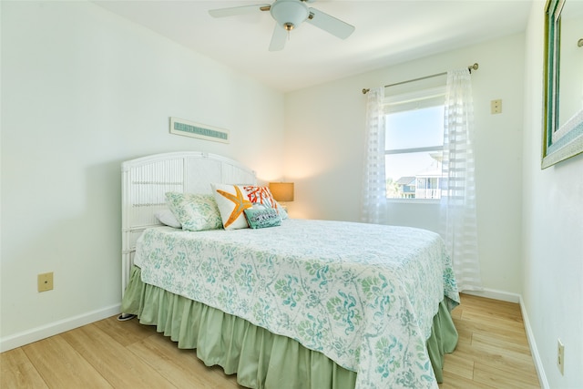 bedroom with light hardwood / wood-style floors and ceiling fan