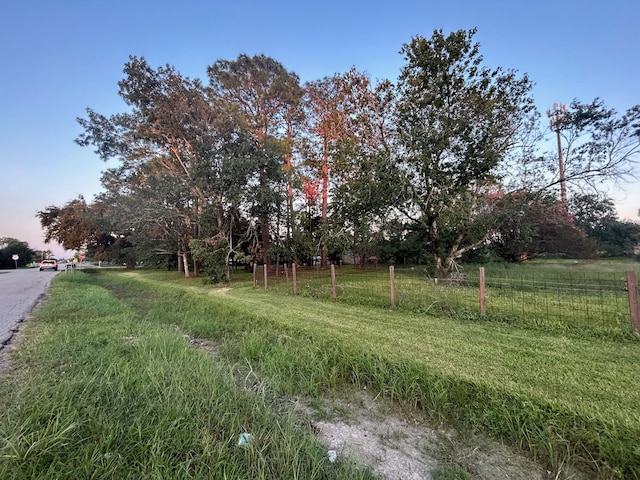 yard at dusk with a rural view