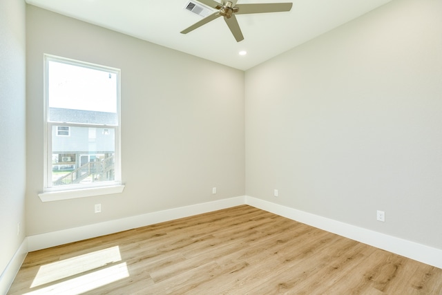 empty room with light wood-type flooring, ceiling fan, and plenty of natural light