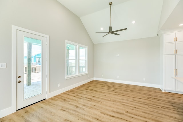 unfurnished living room with light wood-type flooring, ceiling fan, and high vaulted ceiling