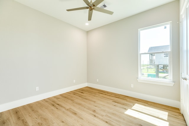 spare room featuring light wood-type flooring and ceiling fan