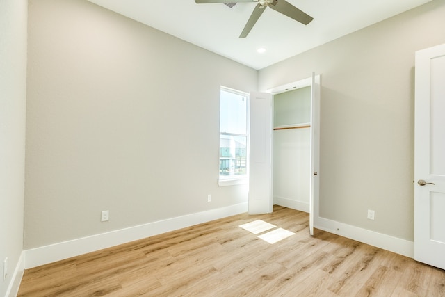 unfurnished bedroom with light hardwood / wood-style floors, ceiling fan, and a closet