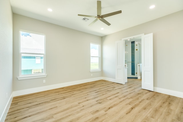 spare room with light wood-type flooring and ceiling fan