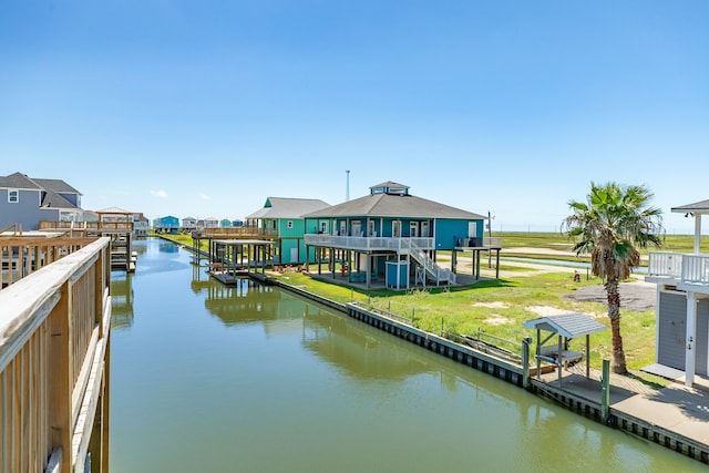 view of dock featuring a yard and a water view