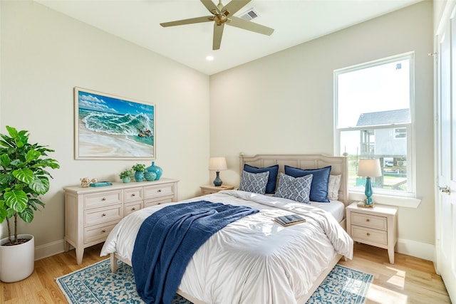 bedroom with light hardwood / wood-style floors and ceiling fan