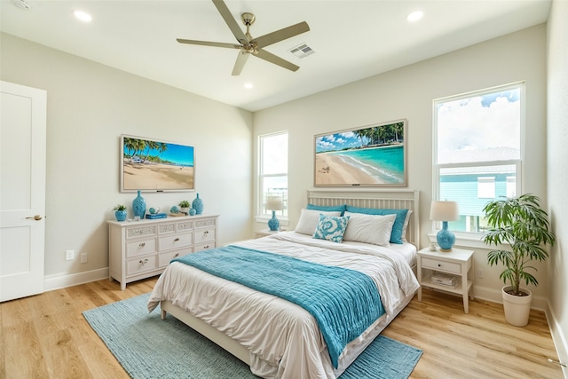 bedroom with ceiling fan and light hardwood / wood-style flooring