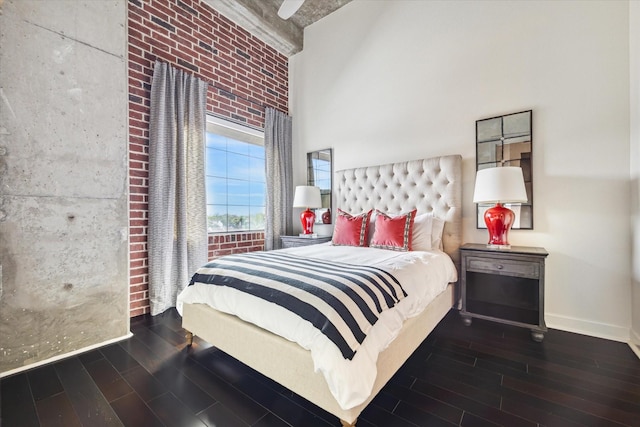 bedroom featuring a high ceiling and dark hardwood / wood-style flooring