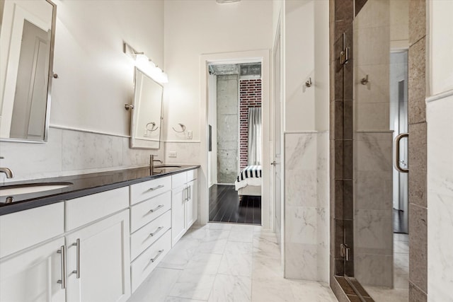 bathroom with vanity, tile walls, and an enclosed shower