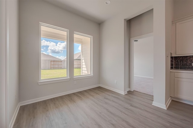 910 Rosewood Trl, Beasley, TX 77417 - unfurnished dining area with baseboards and light wood-type flooring