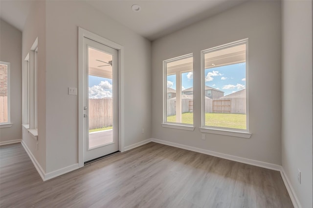 910 Rosewood Trl, Beasley, TX 77417 - interior space with baseboards, wood finished floors, and a healthy amount of sunlight