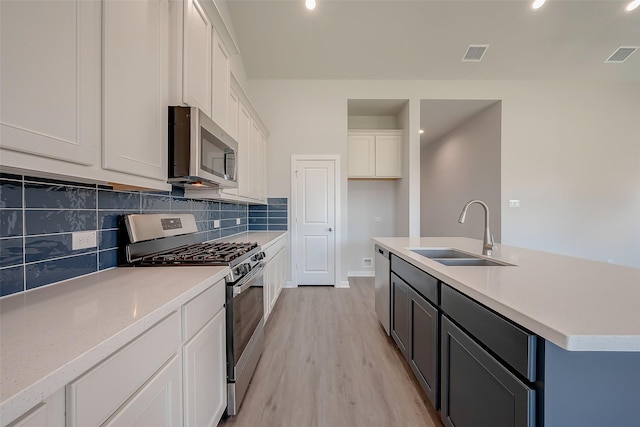 910 Rosewood Trl, Beasley, TX 77417 - kitchen with visible vents, backsplash, a sink, and stainless steel appliances