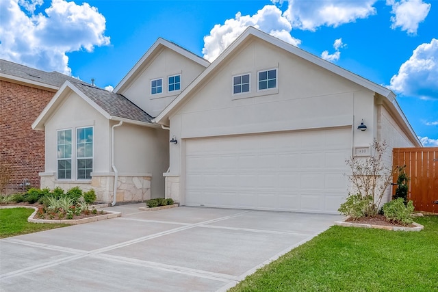 910 Rosewood Trl, Beasley, TX 77417 - view of front of property featuring stone siding, driveway, fence, an attached garage, and stucco siding