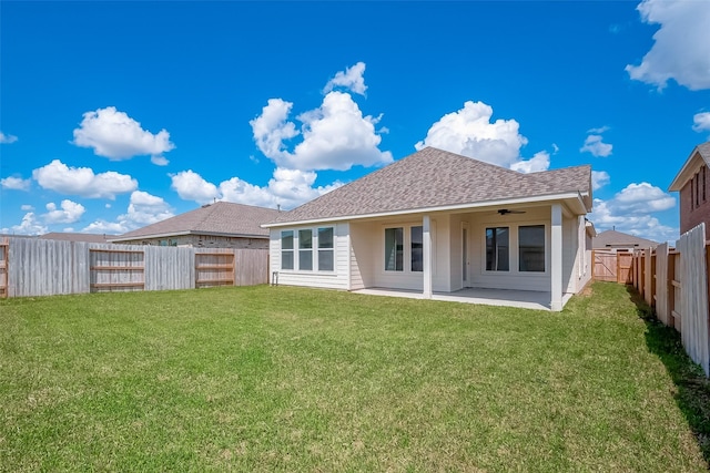 910 Rosewood Trl, Beasley, TX 77417 - back of house featuring a fenced backyard, a ceiling fan, roof with shingles, a lawn, and a patio area
