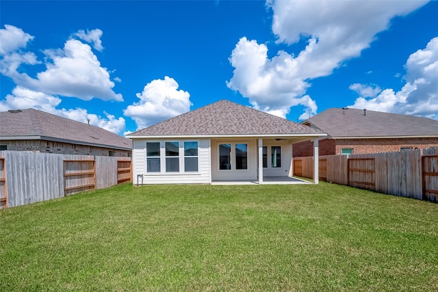 910 Rosewood Trl, Beasley, TX 77417 - back of house with a fenced backyard, roof with shingles, a patio, and a yard