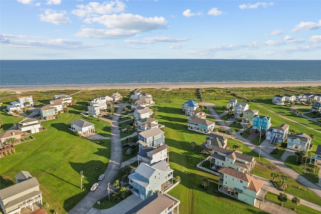 drone / aerial view featuring a water view and a beach view