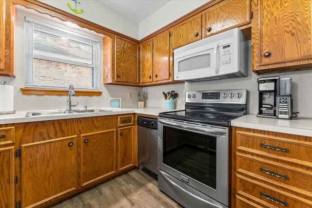 175 S Circle Dr, Livingston, TX 77351 - kitchen featuring a sink, brown cabinetry, light countertops, and appliances with stainless steel finishes