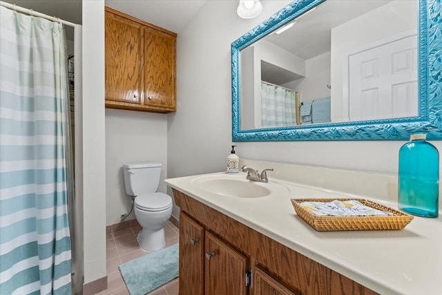 bathroom featuring tile patterned floors, vanity, and toilet