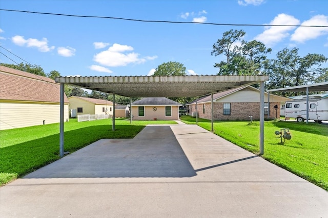 view of front of home with a front yard and a carport