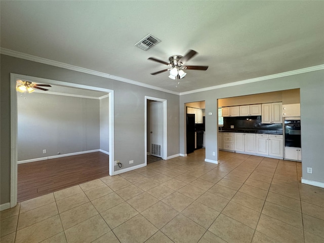 interior space with light wood-type flooring, crown molding, and ceiling fan