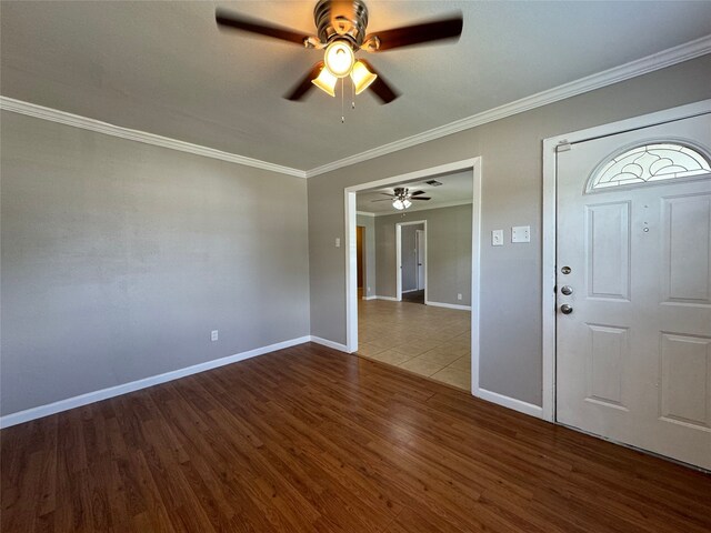 foyer with ornamental molding, wood-type flooring, and ceiling fan