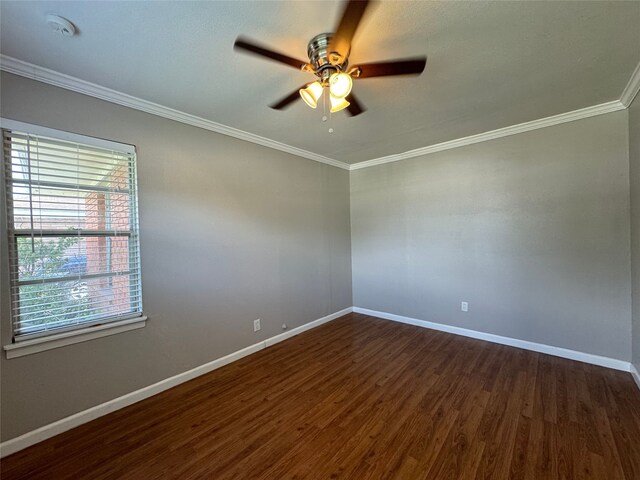 empty room featuring crown molding, dark wood-type flooring, and ceiling fan