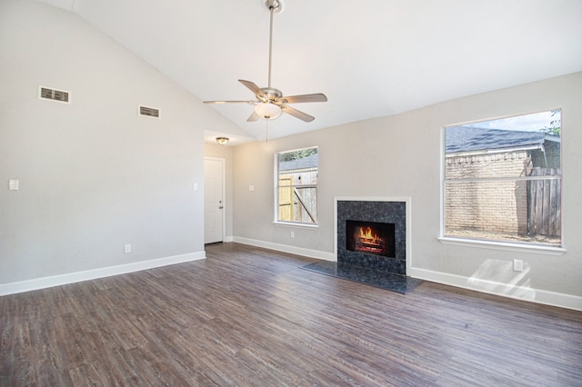 unfurnished living room featuring high vaulted ceiling, a high end fireplace, ceiling fan, and dark hardwood / wood-style flooring