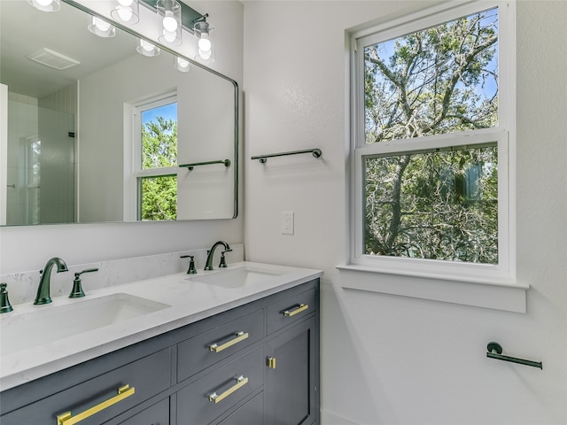 bathroom with vanity and a shower with shower door