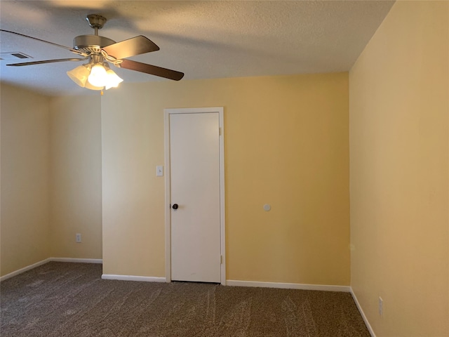 carpeted empty room featuring ceiling fan and a textured ceiling