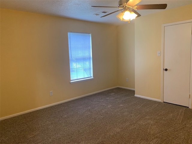 carpeted empty room with ceiling fan and a textured ceiling