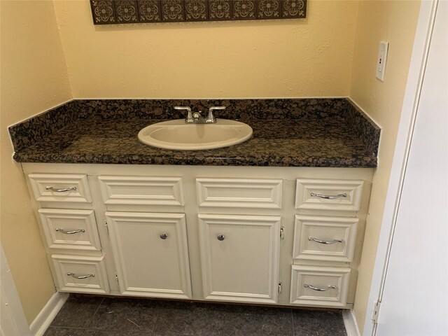 bathroom featuring tile patterned flooring and vanity