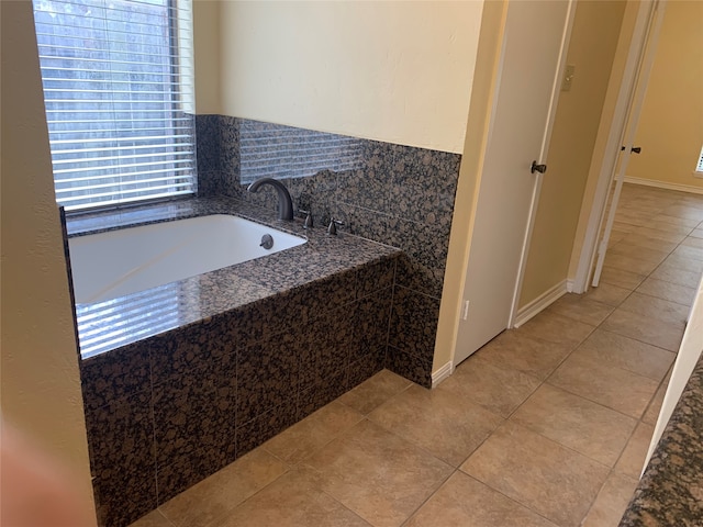 bathroom featuring tiled bath and tile patterned floors