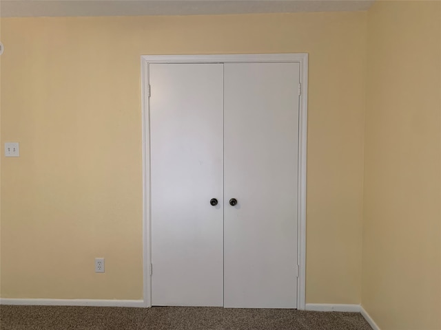 unfurnished bedroom featuring a closet and carpet