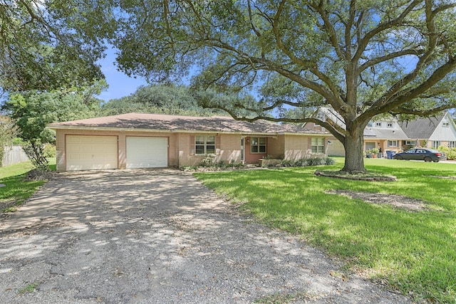 ranch-style home with a front yard and a garage