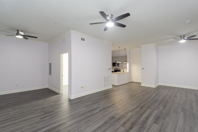 unfurnished living room featuring ceiling fan, electric panel, dark wood-type flooring, and crown molding