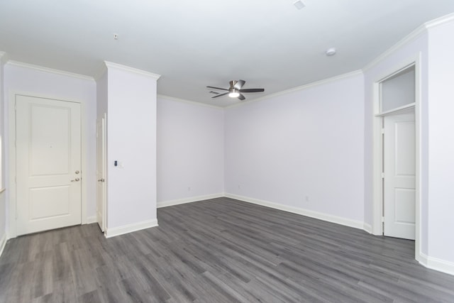 spare room with ceiling fan, crown molding, and dark wood-type flooring