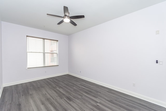 empty room with ceiling fan and dark wood-type flooring