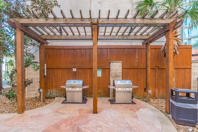 view of patio / terrace with area for grilling and a pergola