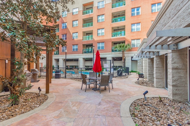 view of patio / terrace featuring grilling area, a balcony, and a pergola