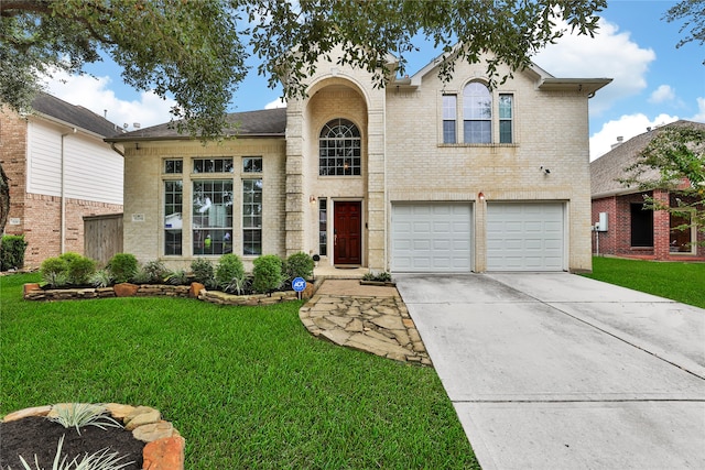 view of front of house with a front yard and a garage