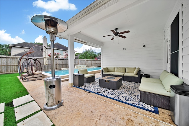 view of patio / terrace featuring an outdoor living space, ceiling fan, and a fenced in pool