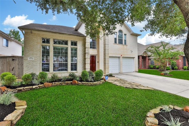 view of front of property featuring a front lawn and a garage