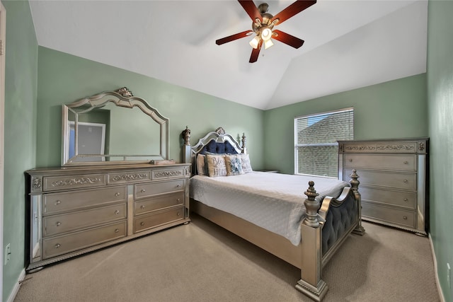 carpeted bedroom with ceiling fan and vaulted ceiling