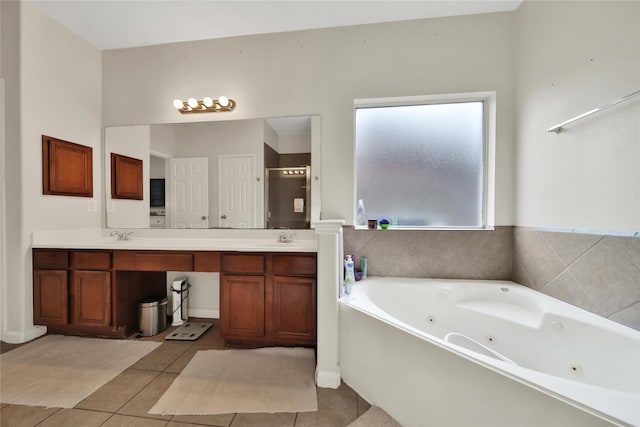 bathroom featuring vanity, tile patterned floors, and a tub